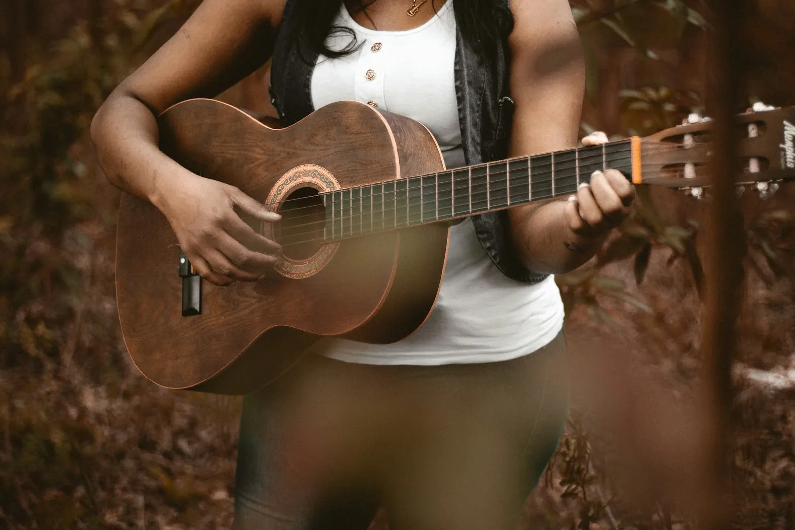 person playing acoustic guitar